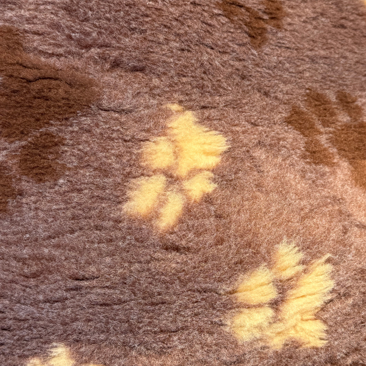 Close-up of a textured brown fabric with yellow accents