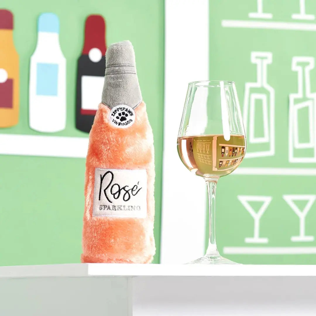 Bottle of 'Rose' sparkling wine with a glass of wine on a green background with bottle illustrations.