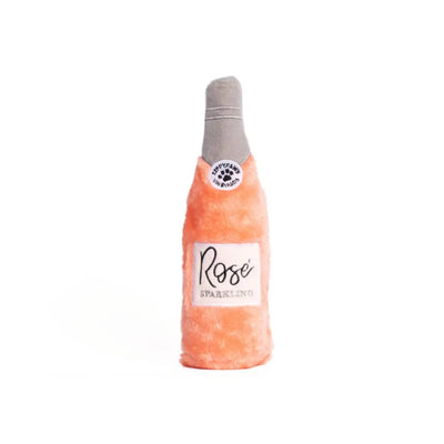 Dog toy shaped like a bottle of Rosé sparkling wine on a white background